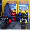 Coin-Operated Racing Motorcycle Arcade Machine with Realistic Controls and Immersive Graphics