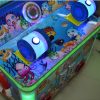 A colorful coin-operated children's two-player fishing game machine shaped like a castle. The machine features vibrant graphics, dual controls, and interactive fishing gameplay. Ideal for arcades, amusement parks, and family entertainment centers, it offers a magical and engaging fishing experience for young players.