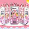 Phone booth style claw machine with colorful stuffed toys inside, attracting players with its vintage design
