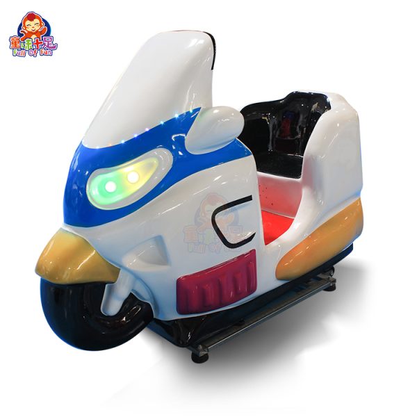 Colorful children's motorcycle kiddie ride machine in a play area
