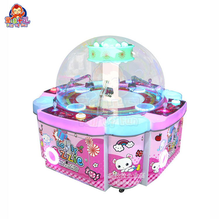 Four-player claw machine with four control panels and colorful lights.