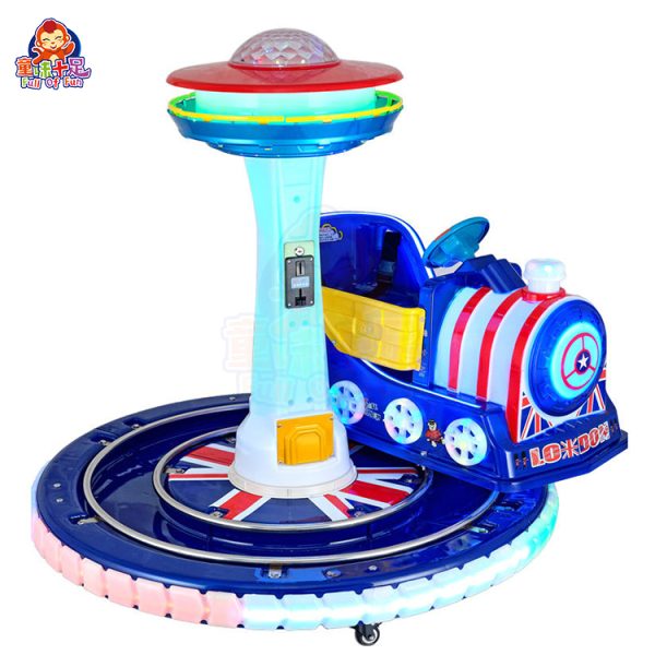 Rotating train kiddie ride on a circular track with colorful lights and sound effects.