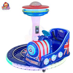 Rotating train kiddie ride on a circular track with colorful lights and sound effects.