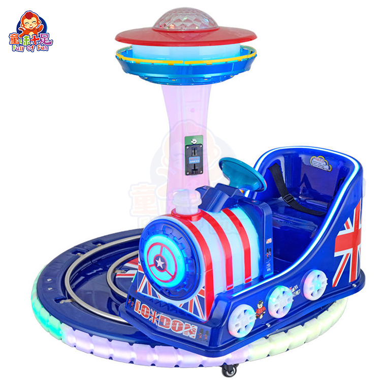 Rotating train kiddie ride on a circular track with colorful lights and sound effects.