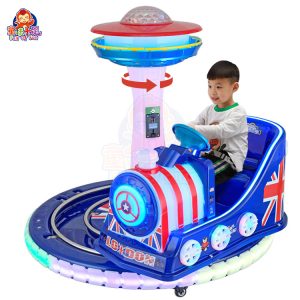 Rotating train kiddie ride on a circular track with colorful lights and sound effects.
