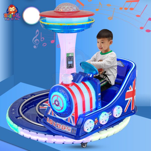 Rotating train kiddie ride on a circular track with colorful lights and sound effects.