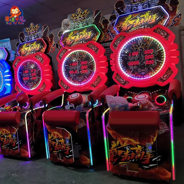 A coin-operated boxing machine with a punch bag, displaying scores and lights.