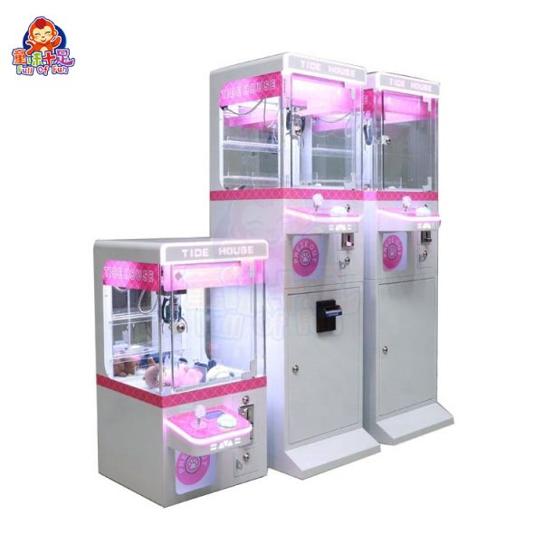 Mini claw machine with vibrant lights and small plush toys inside.