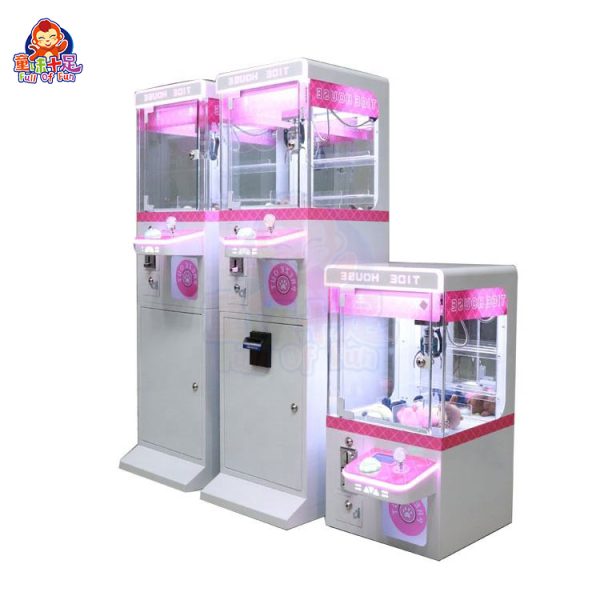 Mini claw machine with vibrant lights and small plush toys inside.