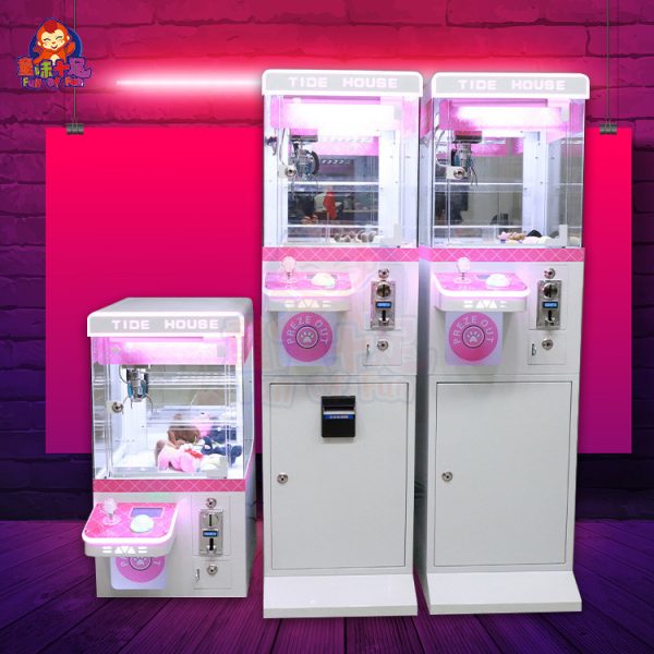 Mini claw machine with vibrant lights and small plush toys inside.