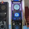 Coin-operated dart game machine with two screens for multiplayer competitions.