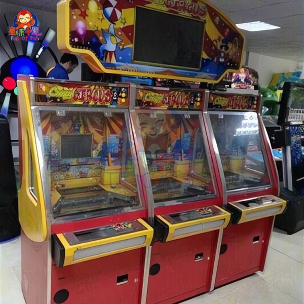 Three-player circus-themed coin pusher machine with vibrant lights and sound effects.