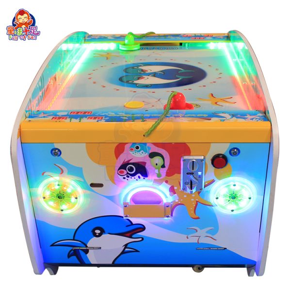 Children playing on a coin-operated dual-player air hockey machine.