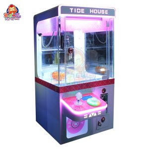 Mini máquina de garras compacta que funciona con monedas, ideal para el entretenimiento de los niños.