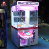 Compact coin-operated mini claw machine for children’s amusement.